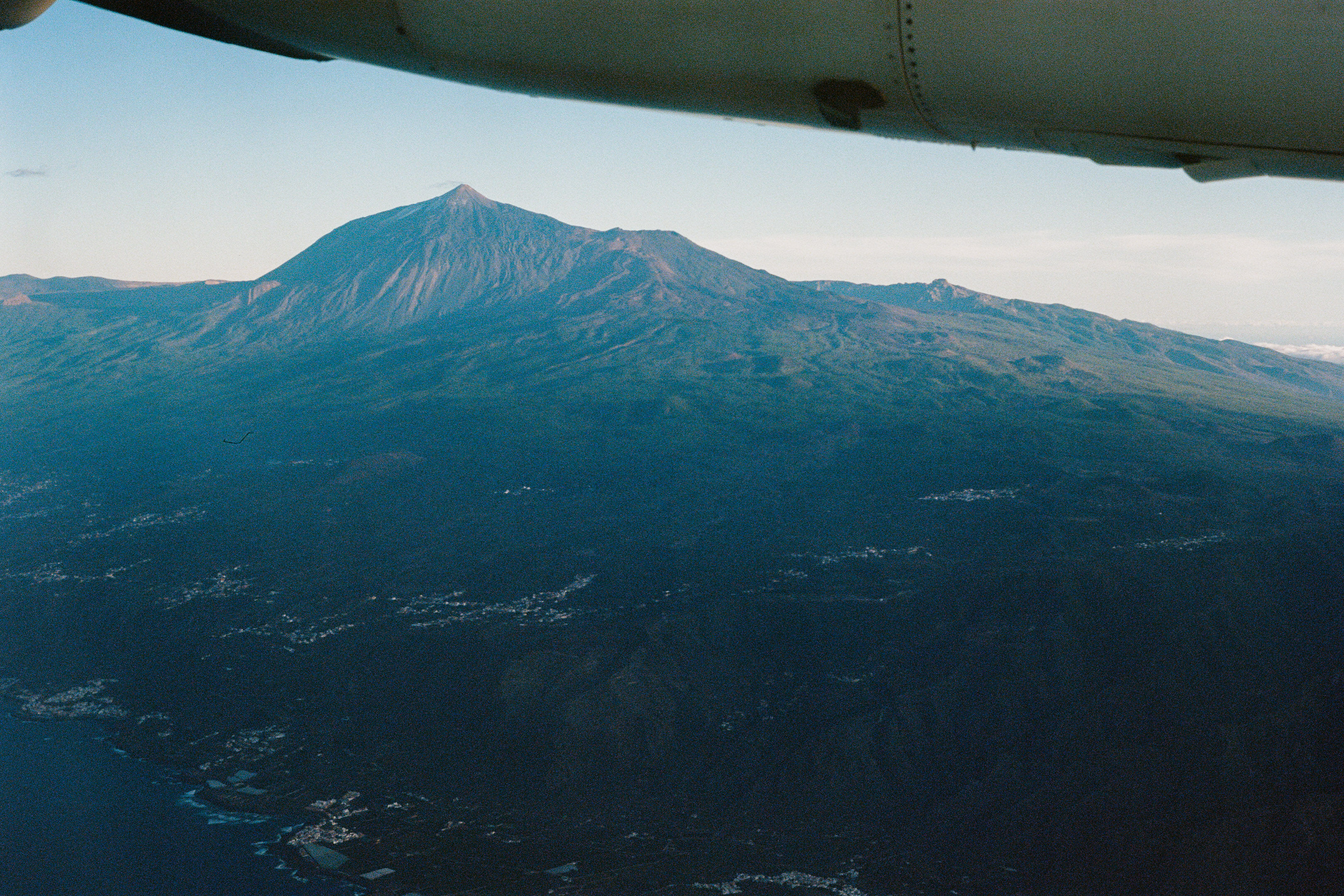 Airplane wing and volcano Tede in the sunset