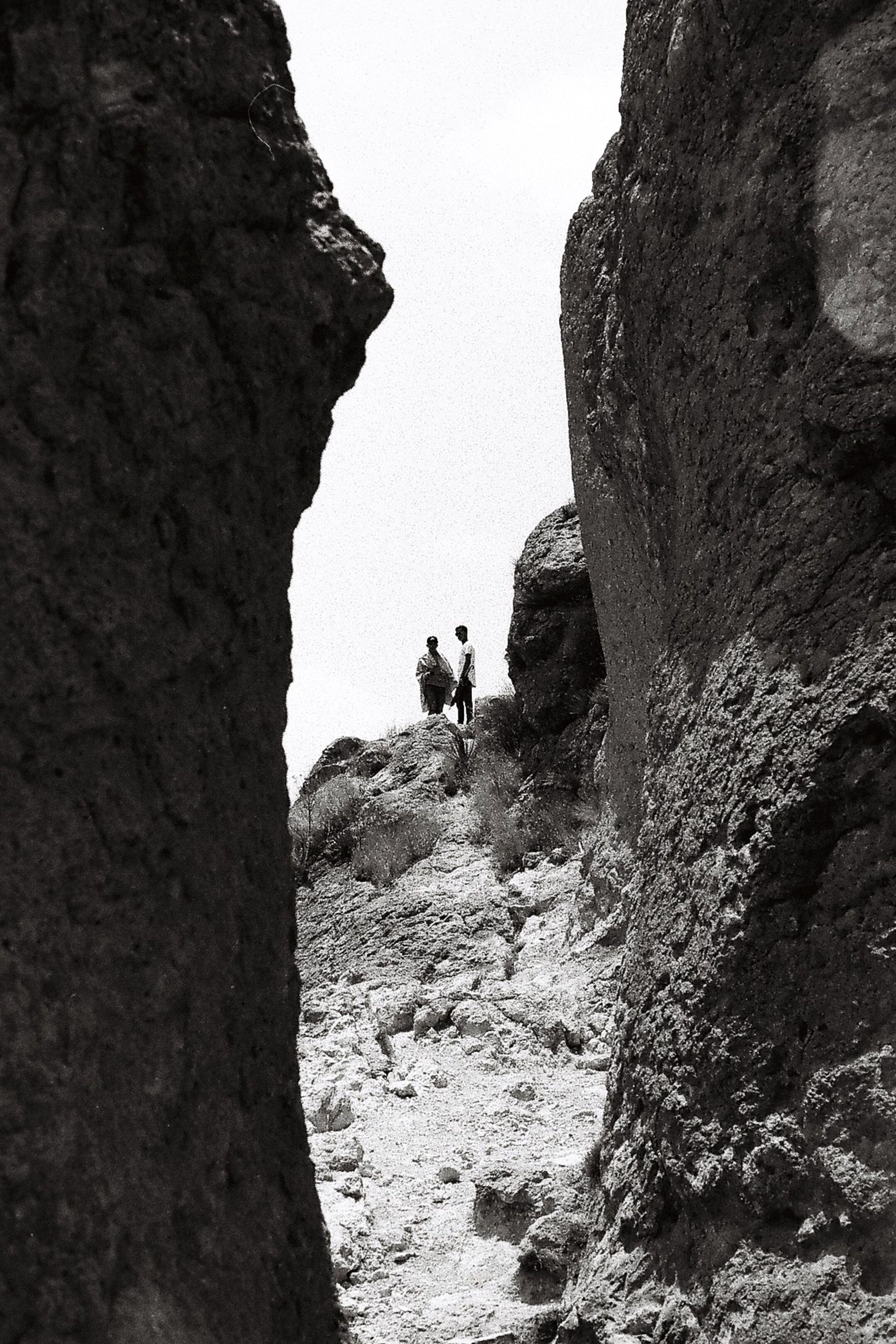 Gap of rocks and two men