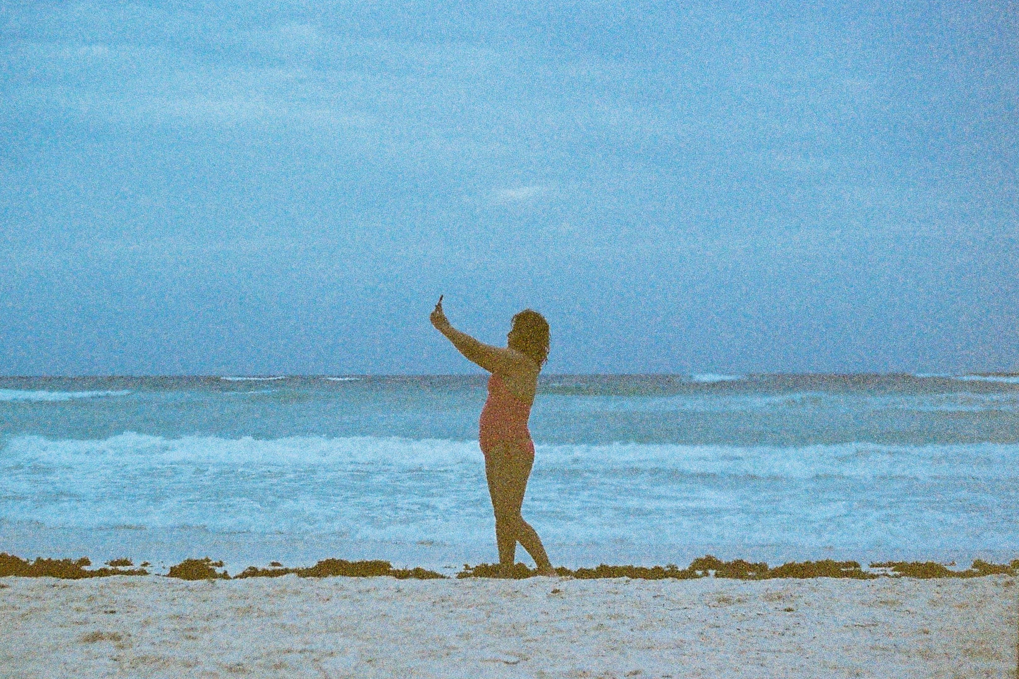 woman at the beach making a selfie