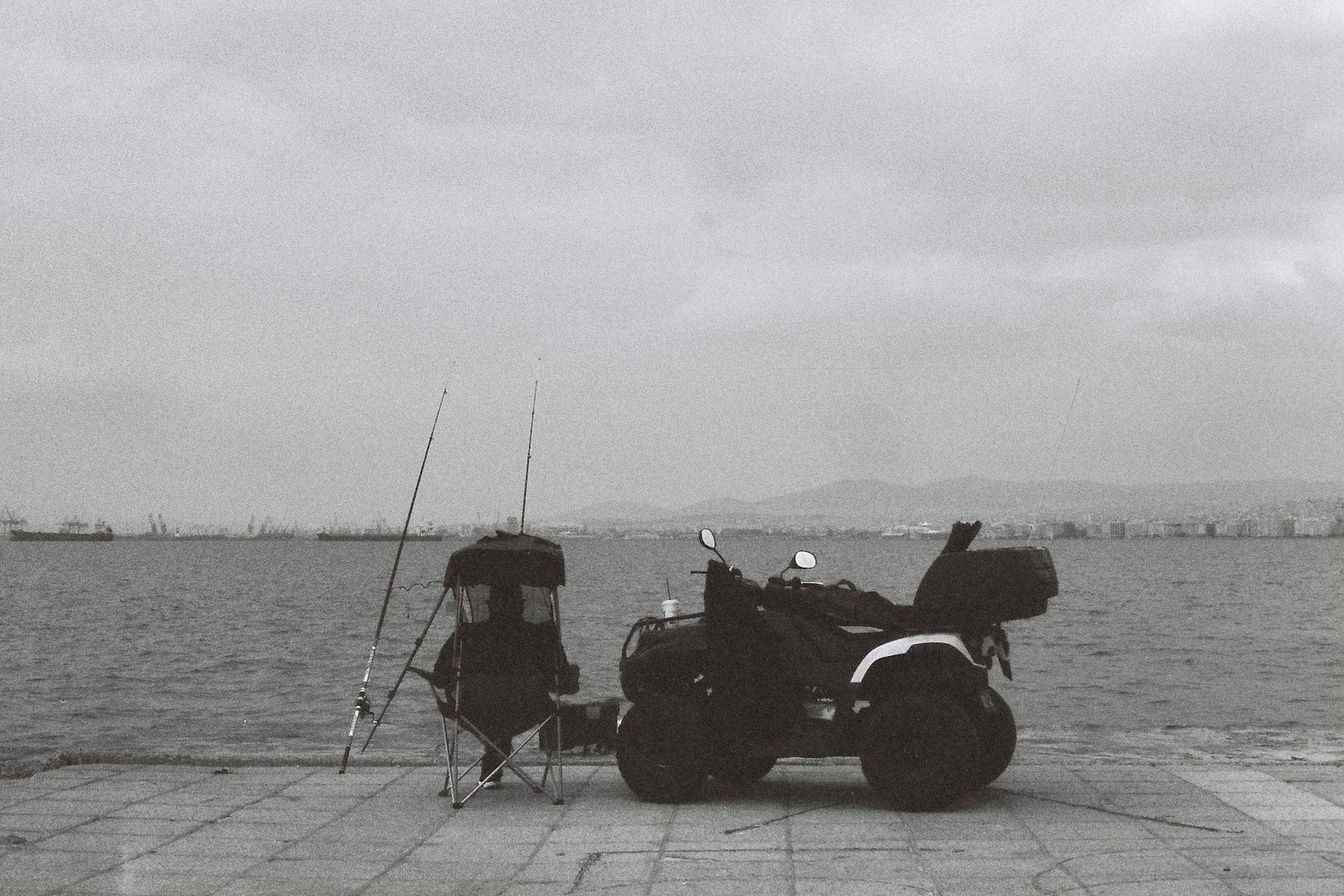 fishing man and quad looking towards the coastline